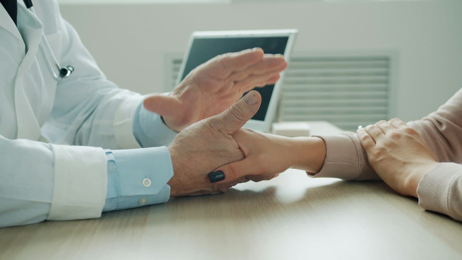 Profesional conversa con una paciente en un escritorio